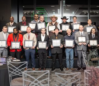 Group of PEP graduates proudly holding framed certificates at completion ceremony